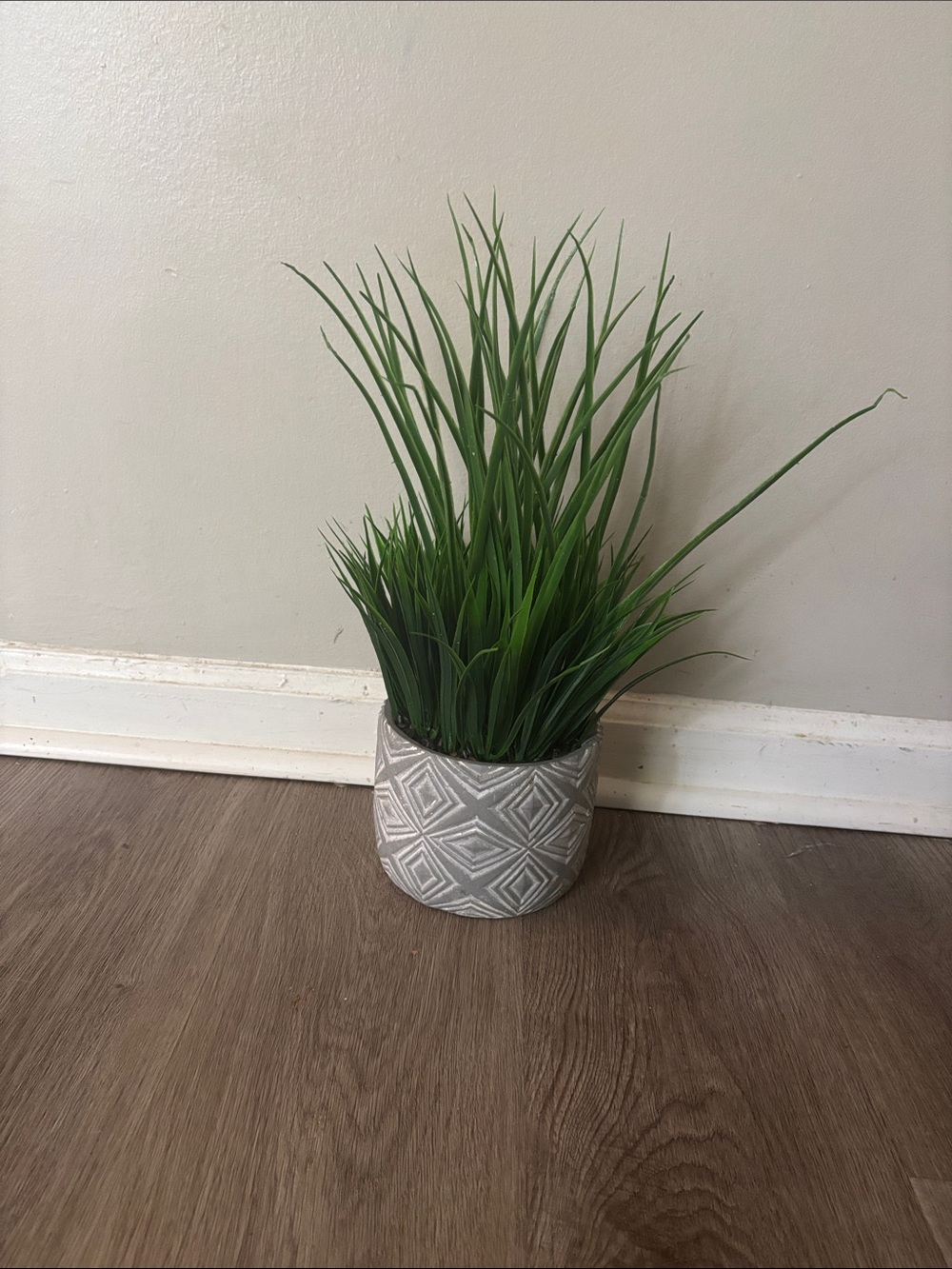 Decorative Green Grass Plant in Textured Gray Ceramic Pot
